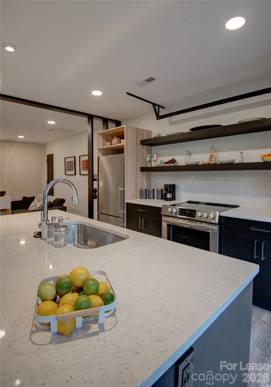 3945 Rockfern Road, Unit B Charlotte, NC 28217 - Photo 22 of 45 a kitchen with stainless steel appliances kitchen island granite countertop a sink and a refrigerator