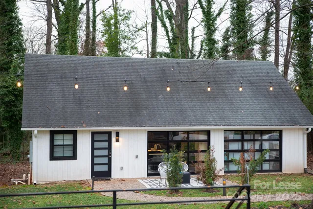 a view of a yard in front of a house with large trees