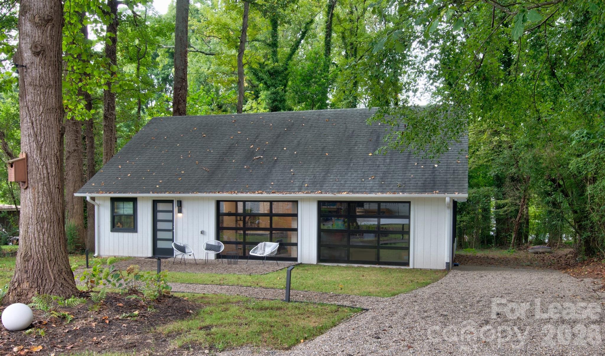 3945 Rockfern Road, Unit B Charlotte, NC 28217 - Photo 41 of 45 a front view of a house with a garden and yard