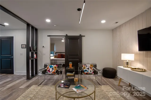 a room with furniture a rug and a flat screen tv