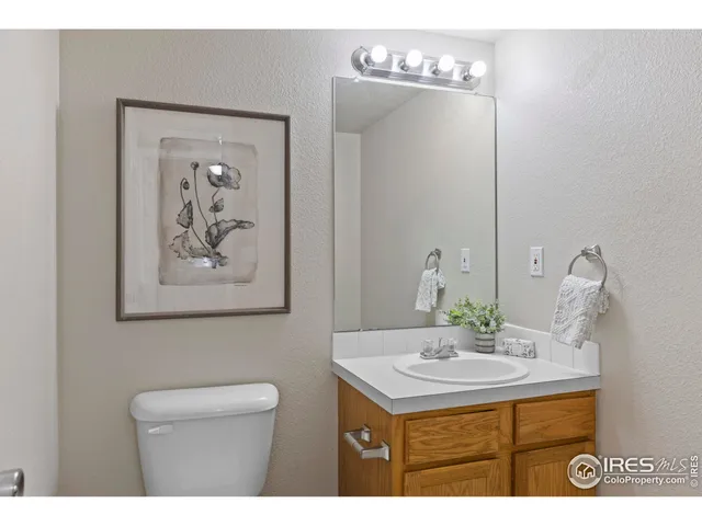 a bathroom with a sink a mirror and a toilet