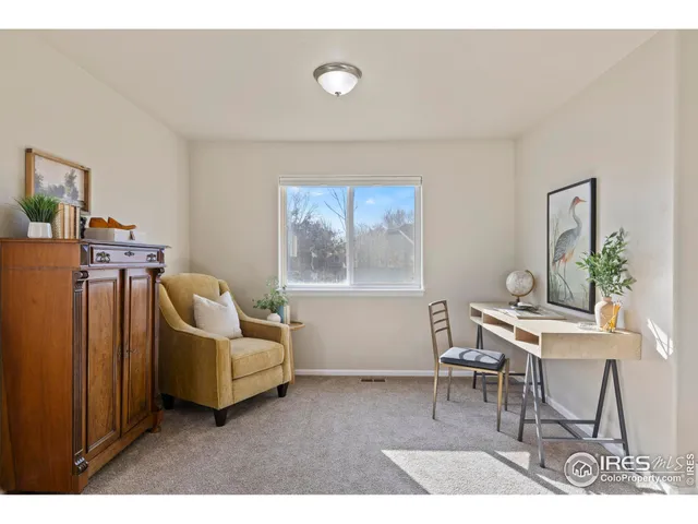 a living room with furniture a table and a window