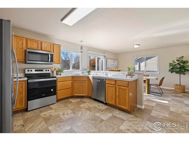 a kitchen with a sink cabinets and stainless steel appliances