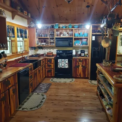 a kitchen with stainless steel appliances granite countertop a stove and a wooden cabinets