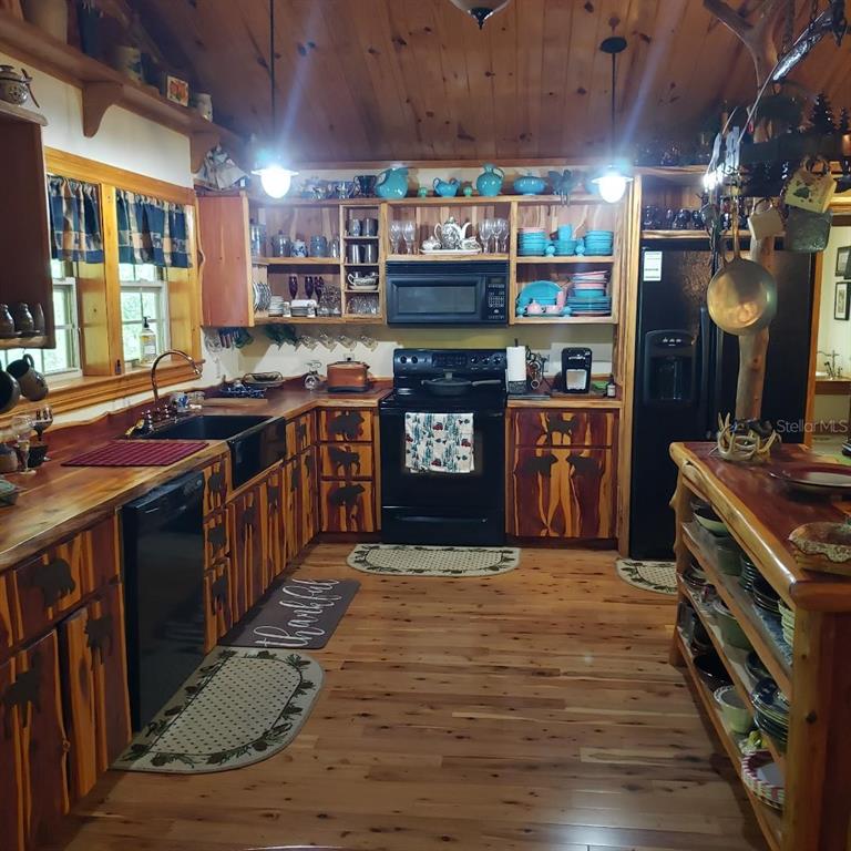 28063 31st Road Branford, FL 32008 - Photo 5 of 29 a kitchen with stainless steel appliances granite countertop a stove and a wooden cabinets