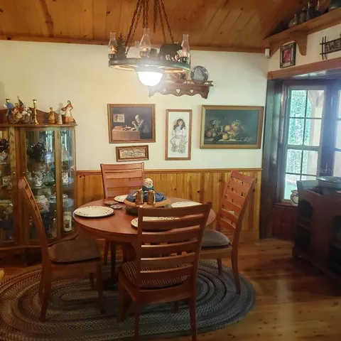 a view of a dining room with furniture and chandelier