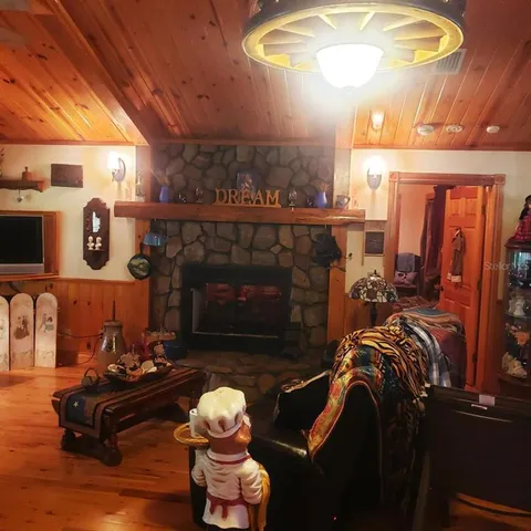 a living room with furniture a fireplace and a table