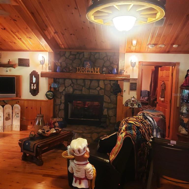 28063 31st Road Branford, FL 32008 - Photo 9 of 29 a living room with furniture a fireplace and a table