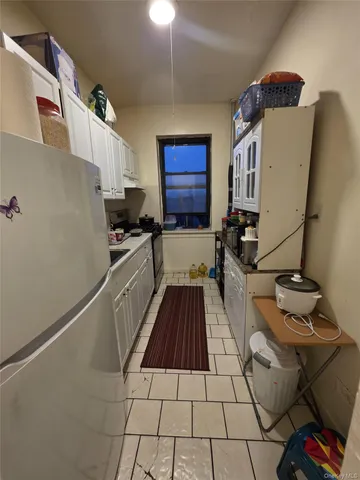 a kitchen with a sink and wooden floor
