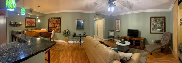 a living room with furniture and a wooden floor