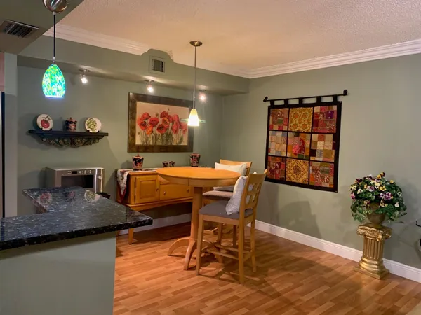 a view of a dining room with furniture and wooden floor