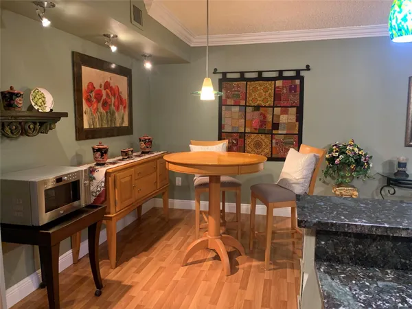 a kitchen with kitchen island a counter top space a sink a stove and a refrigerator