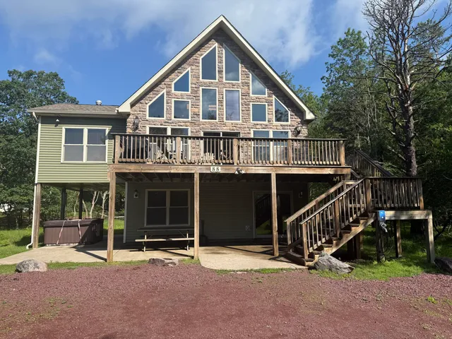 a front view of a house with a yard and parking space
