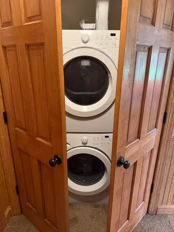 a view of a patio with a table chairs and a backyard