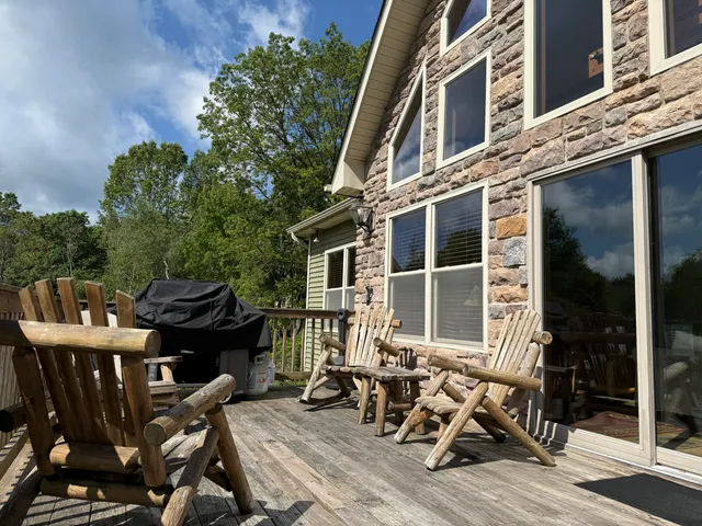 a view of a patio with table and chairs and wooden floor