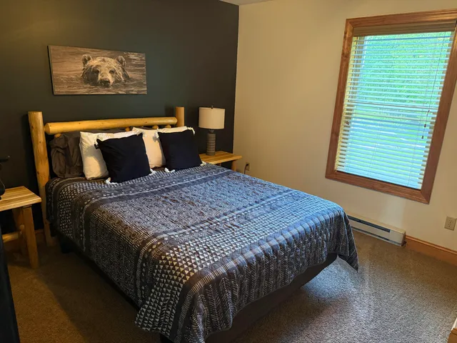 a bedroom with bed and window