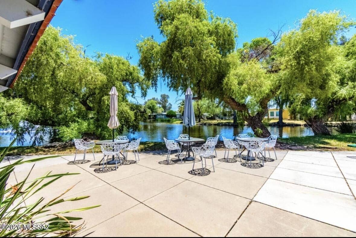 4550 North Flowing Wells Road, Unit 65 Tucson, AZ 85705 - Photo 1 of 50 a view of a patio with a table and chairs under an umbrella
