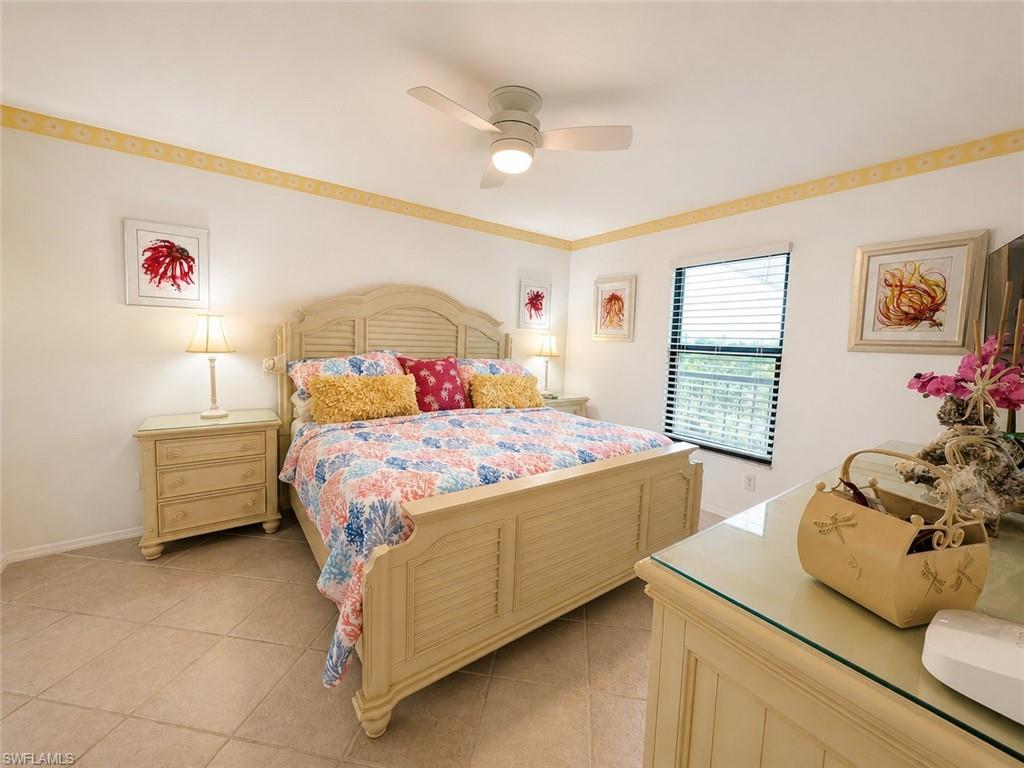 600 Neapolitan Way, Unit 449 Naples, FL 34103 - Photo 11 of 44 Spacious room featuring tile flooring, a window with horizontal blinds, and a ceiling fan with integrated lighting