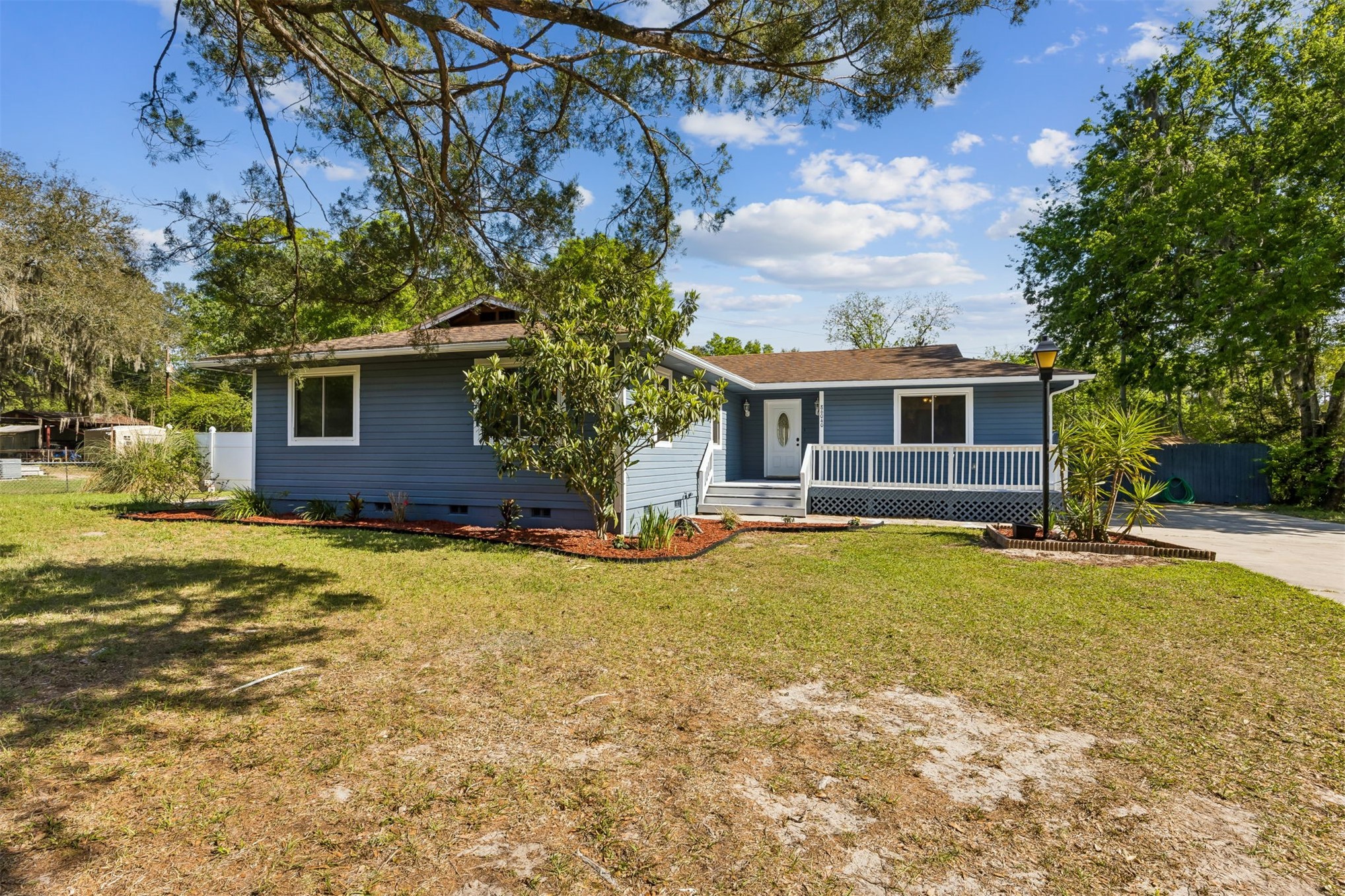 a front view of house with yard and trees