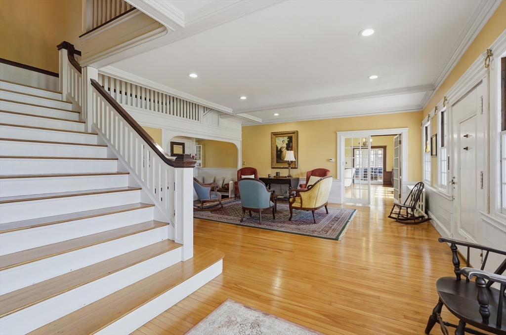 372 Main Street Amesbury, MA 01913 - Photo 22 of 42 a living room with furniture or stairs and a floor to ceiling window
