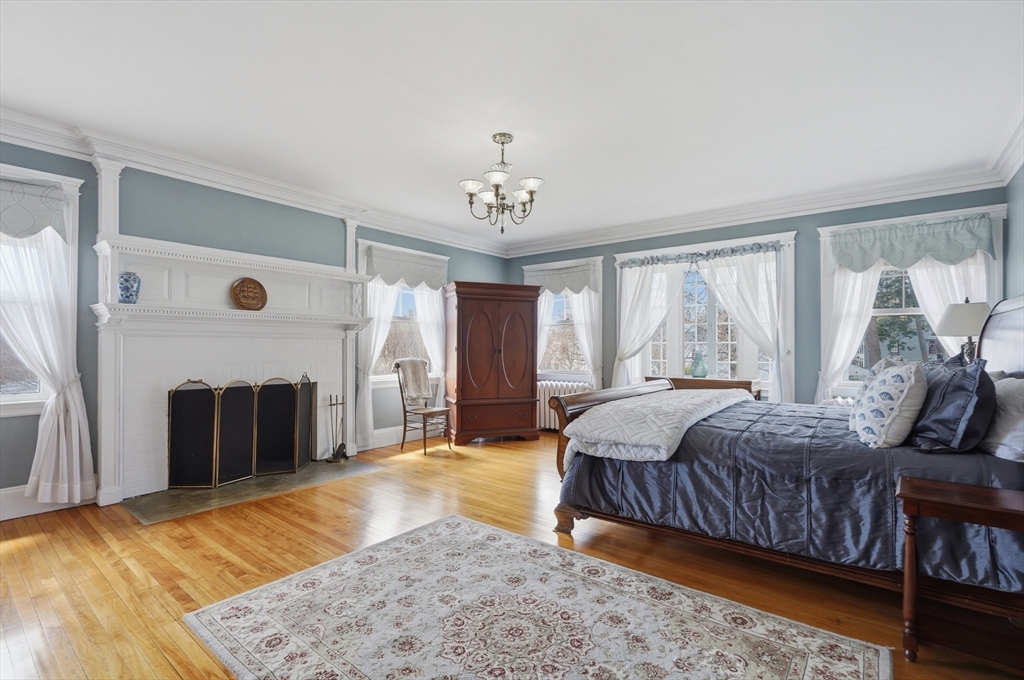 372 Main Street Amesbury, MA 01913 - Photo 24 of 42 a bedroom with a bed and a fireplace