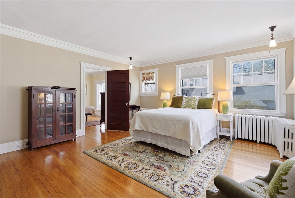 372 Main Street Amesbury, MA 01913 - Photo 29 of 42 a bedroom with a bed and wooden floor