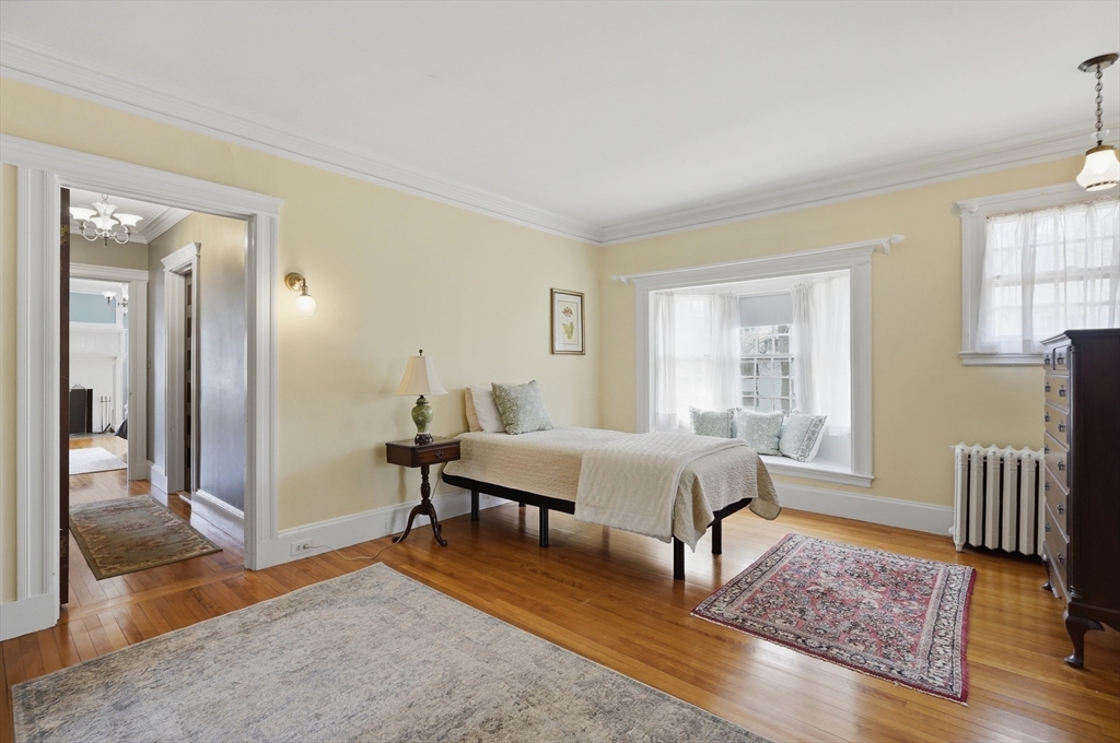 372 Main Street Amesbury, MA 01913 - Photo 31 of 42 a spacious bedroom with a bed and wooden floor