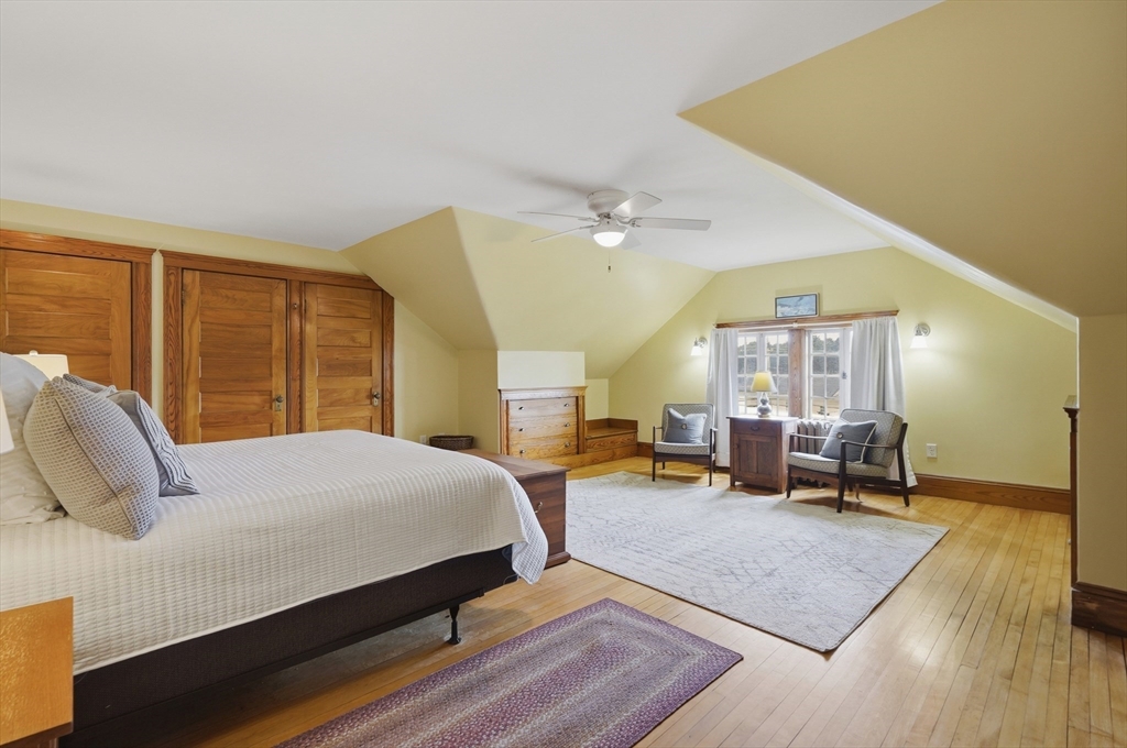 372 Main Street Amesbury, MA 01913 - Photo 33 of 42 a bedroom with a bed a large window with table and chair