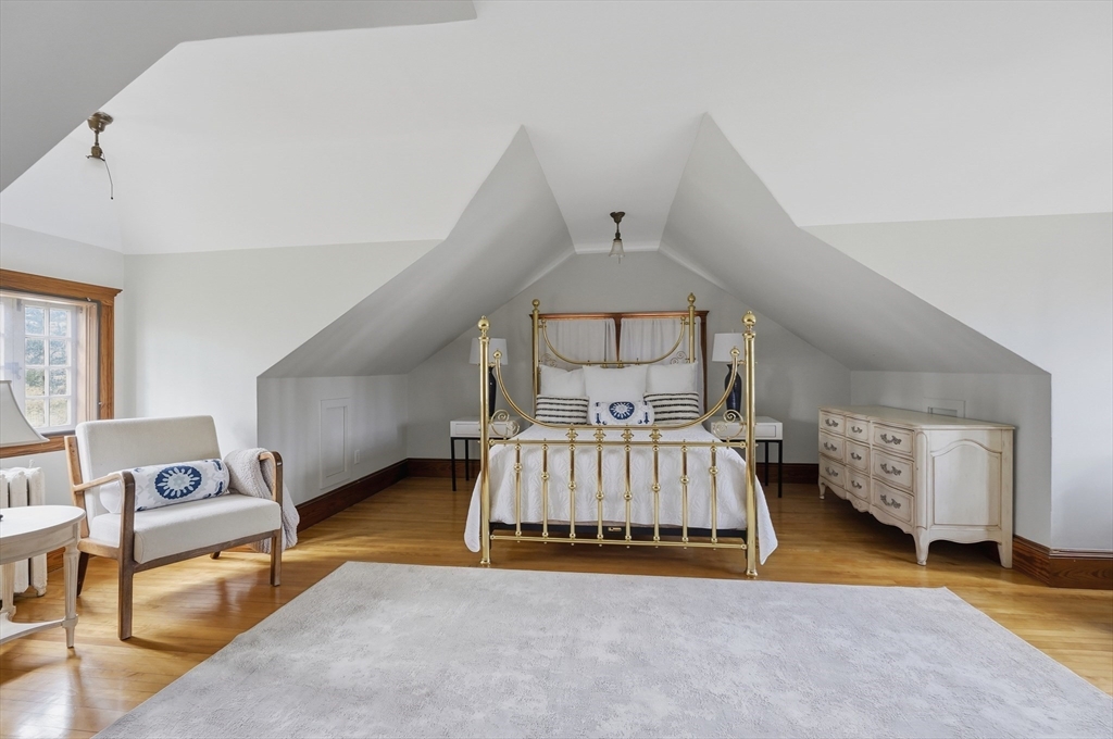 372 Main Street Amesbury, MA 01913 - Photo 34 of 42 a spacious bedroom with a bed and a couch