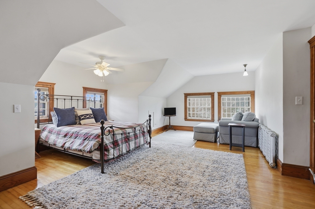 372 Main Street Amesbury, MA 01913 - Photo 35 of 42 a bedroom with a bed and wooden floor