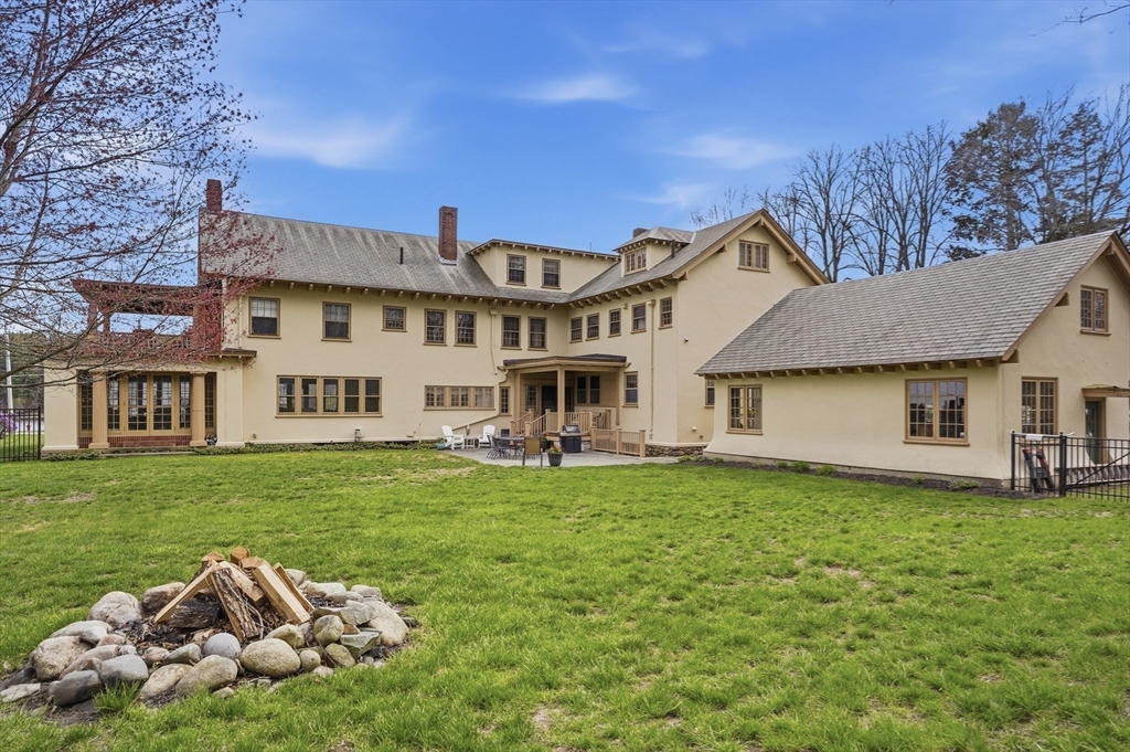 372 Main Street Amesbury, MA 01913 - Photo 38 of 42 a front view of a house with a garden and trees