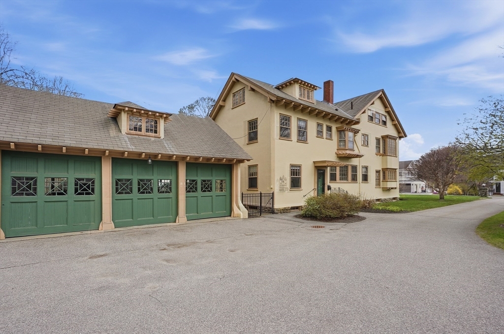 372 Main Street Amesbury, MA 01913 - Photo 39 of 42 a front view of a house with a yard and garage