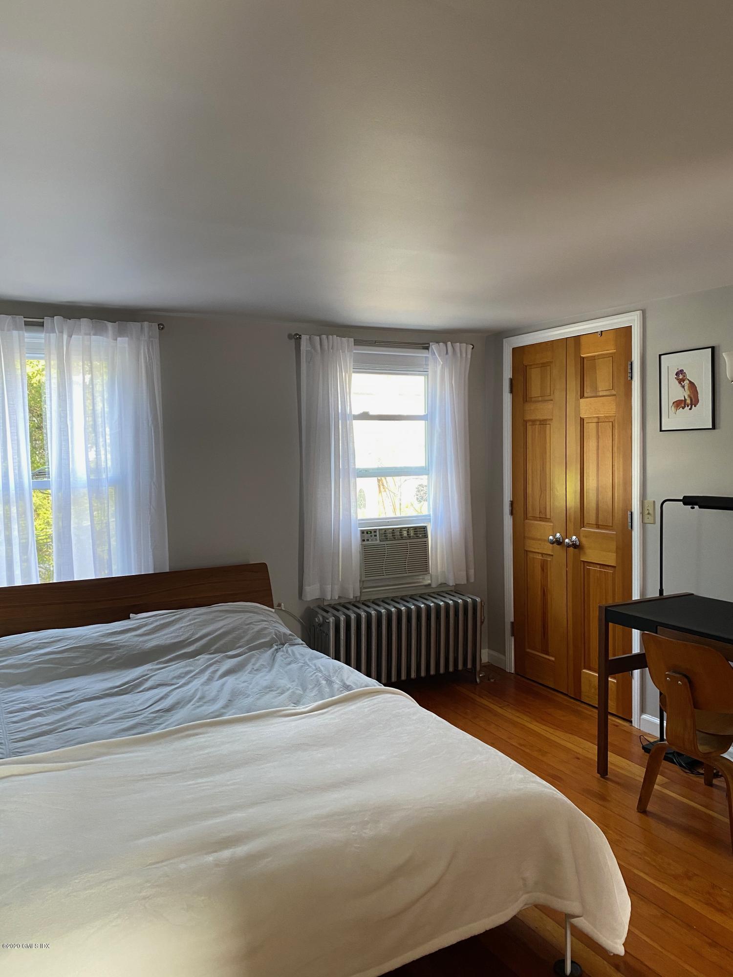 22 Division Street Greenwich, CT 06830 - Photo 6 of 28 a bedroom with a bed and a window