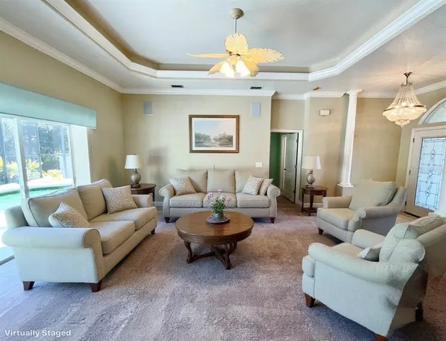 a living room with furniture a lamp and a large window