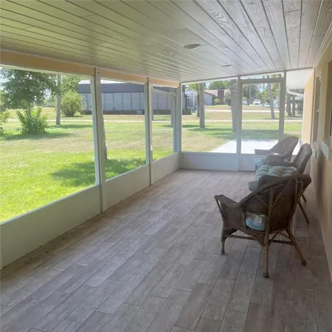 a view of a room with furniture and wooden floor