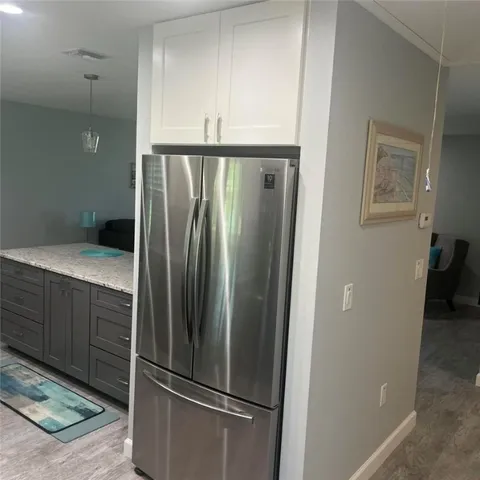 a metallic refrigerator freezer sitting in a kitchen