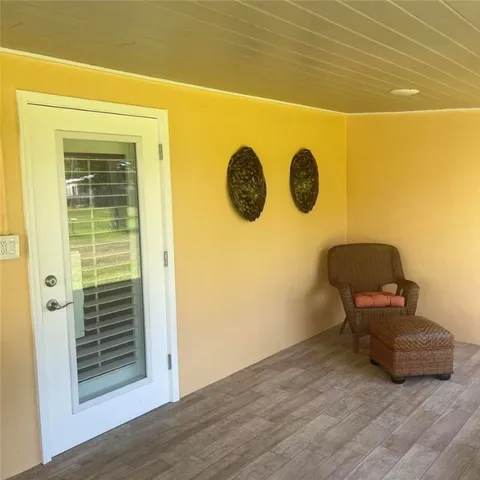 a view of a wooden door and chair
