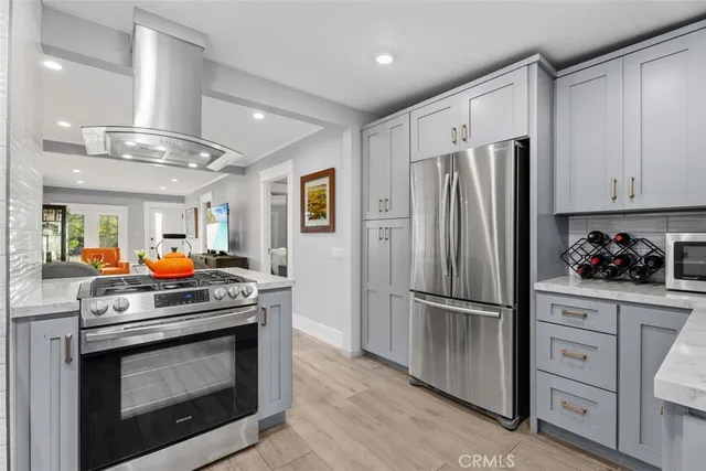 a kitchen with stainless steel appliances a stove microwave and refrigerator