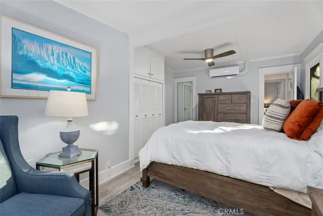 a bedroom with a bed and a painting on the wall