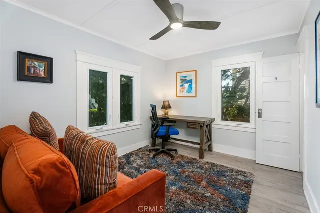 a living room with furniture a rug and a window