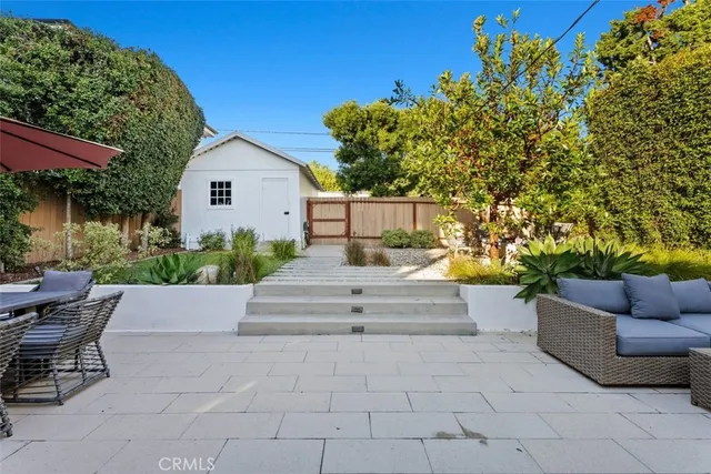 a view of patio with couches and potted plants