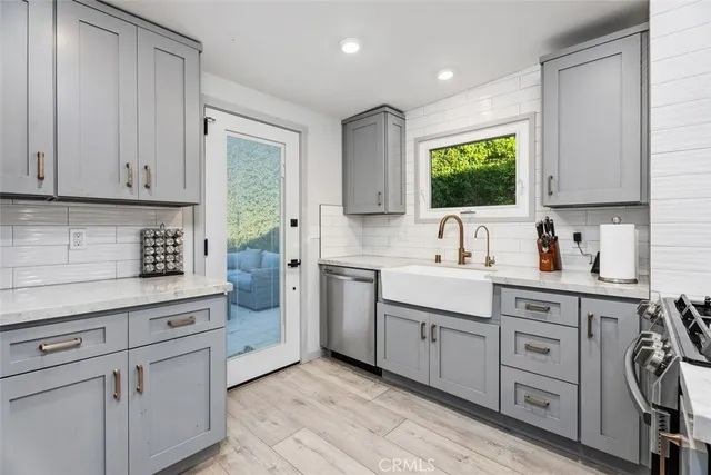 a kitchen with white cabinets and white appliances