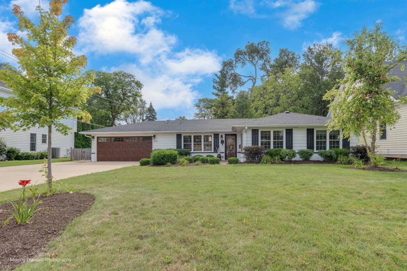 1845 Howard Street Wheaton, IL 60187 - Photo 2 of 41 a front view of a house with a garden