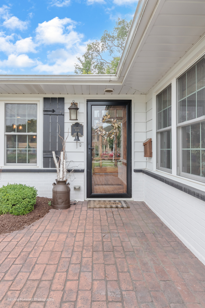1845 Howard Street Wheaton, IL 60187 - Photo 3 of 41 a front view of a house with a yard and potted plants
