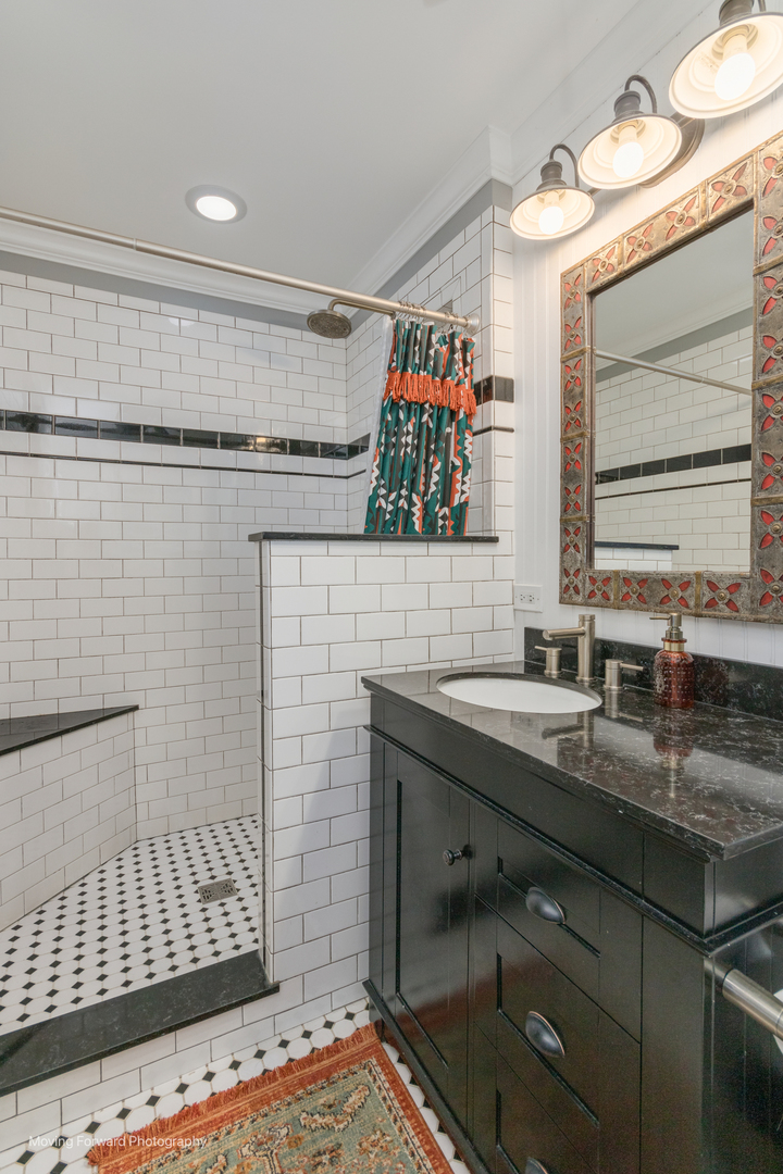 1845 Howard Street Wheaton, IL 60187 - Photo 35 of 41 a bathroom with a sink and a mirror