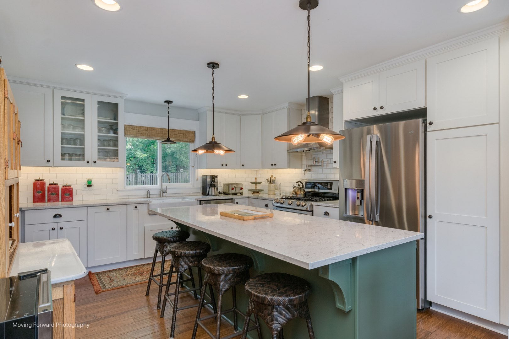 1845 Howard Street Wheaton, IL 60187 - Photo 8 of 41 a kitchen with stainless steel appliances granite countertop a table chairs refrigerator and sink