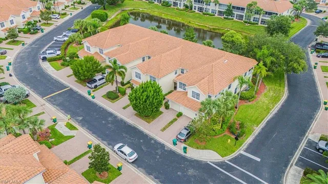 a aerial view of a house with a yard table and chairs