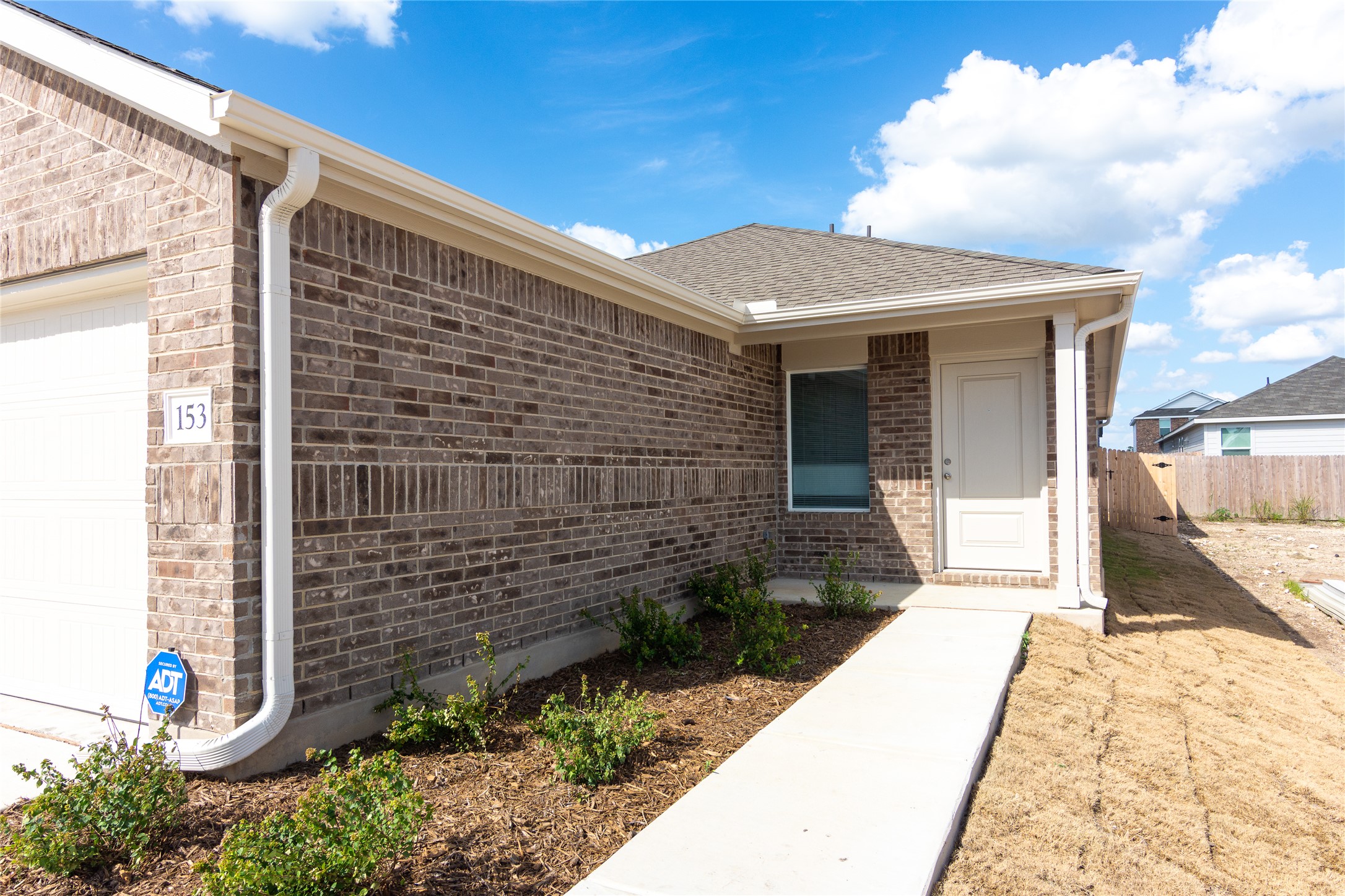 153 Star Packer Lane Jarrell, TX 76537 - Photo 1 of 30 A newly constructed brick home with a pristine pathway welcomes you.