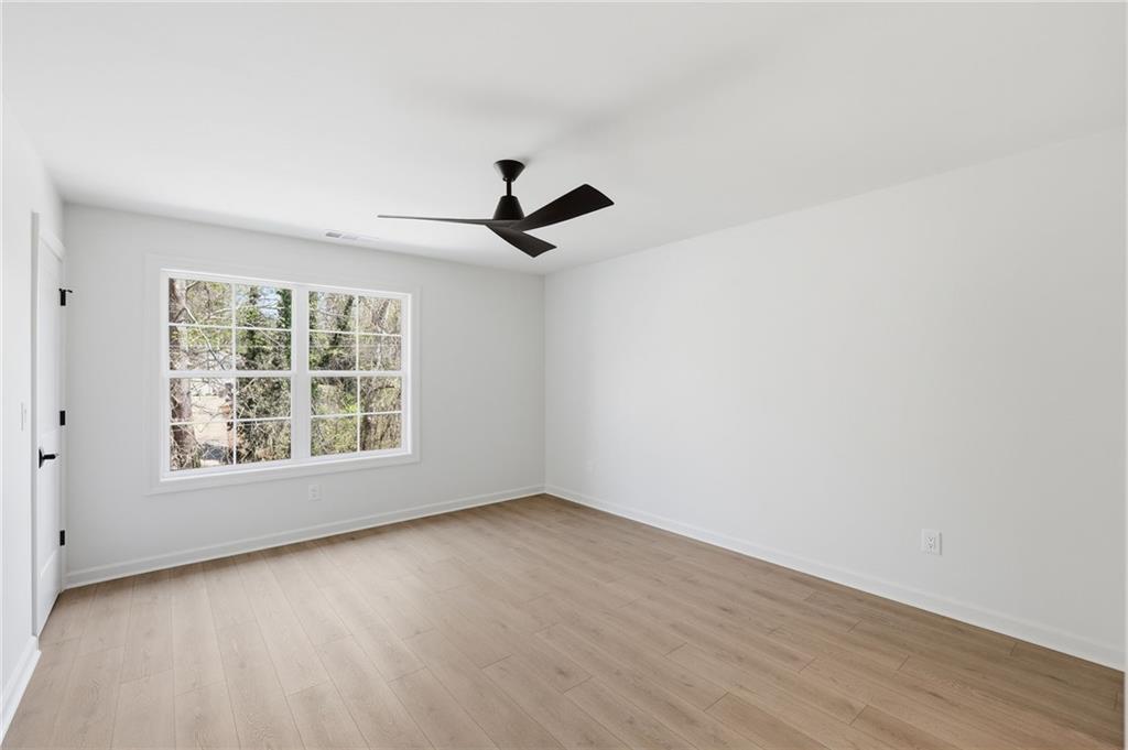 1121 Riverside Terrace Gainesville, GA 30501 - Photo 25 of 39 an empty room with wooden floor and windows