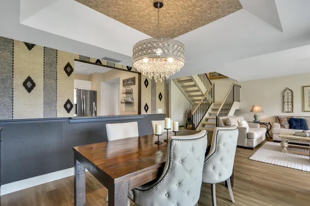 a kitchen with stainless steel appliances granite countertop a sink a stove and white cabinets